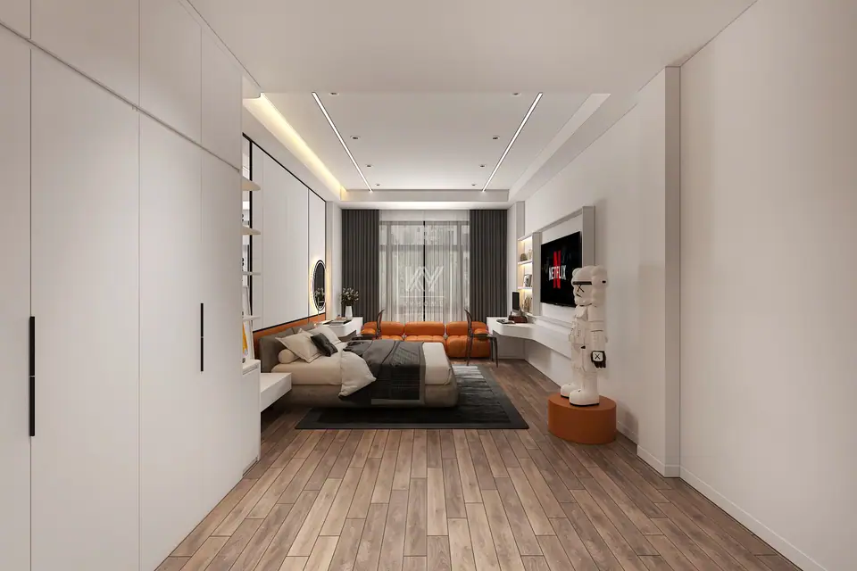 Phòng ngủ dài với tủ áo trắng kịch trần, sàn gỗ nâu và sofa cam